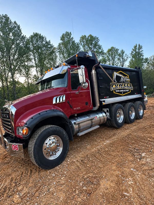 Powell Construction Mack dump truck with company logo on the bed